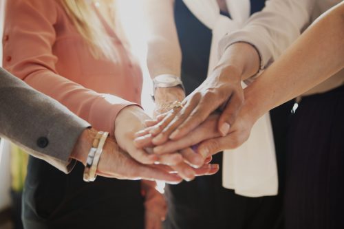 Women joining hands in the middle Women joining hands in the middle
