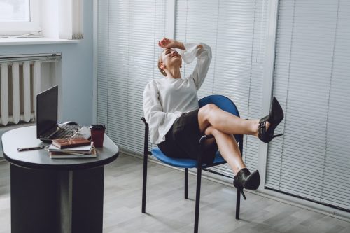 Young business woman take it easy working and resting in office. Niksen, do nothing, overwork, Life quality, living balance concept Young business woman take it easy working and resting in office. Niksen, do nothing, overwork, Life quality, living balance concept.